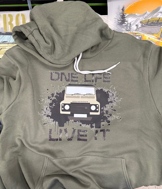 Green hoodie with a graphic of a car and text 'One Life, Live It' on a blurred background
