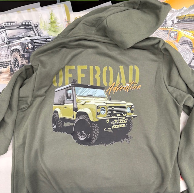 Green hoodie with off-road vehicle graphic and 'Offroad Adventure' text on a surface with other items.