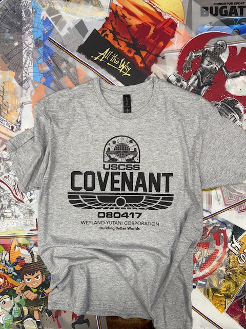 Gray t-shirt with black logo and text on a colorful, chaotic background